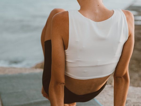 A close-up shot of a yoga mat and water bottle in a calm, dimly lit room.